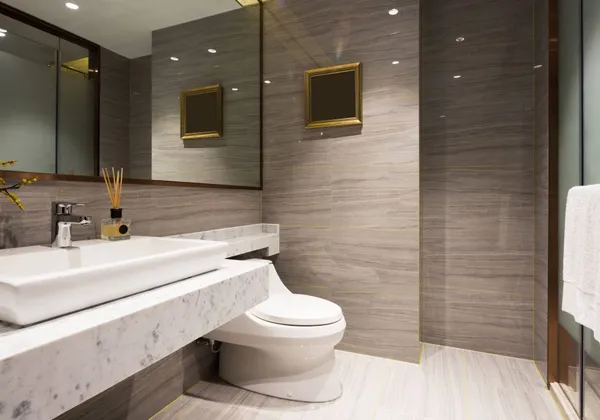 Bathroom with marble vanity top and stone-effect wall tiling